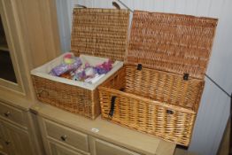 Two wicker hampers and a quantity of toys