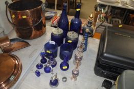 A quantity of blue glass ornaments, scent bottles
