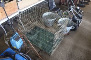 A metal pet cage with floor cushion