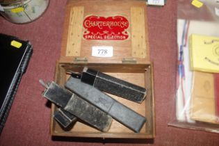 A vintage cigar box and three cutthroat razors