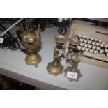 A pair of brass peacock decorated candlesticks and