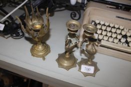 A pair of brass peacock decorated candlesticks and