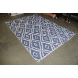 A large blue and cream cotton rug approx. 9'2" x 6