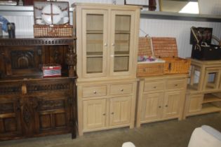 A modern light wood effect bookcase fitted two dra