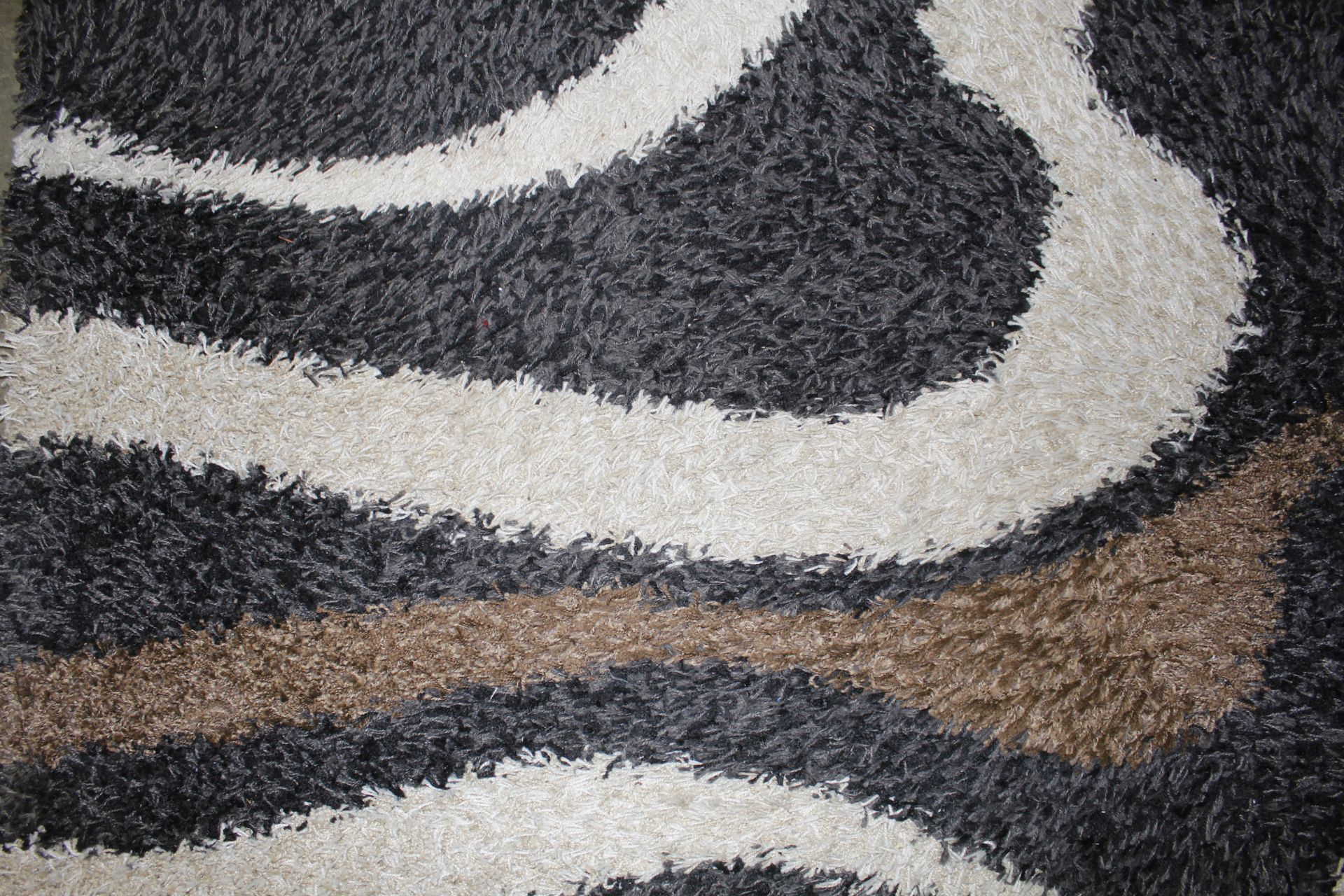 A black, white and brown patterned wool rug approx - Image 2 of 3