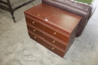 A pair of modern laminate three drawer bedside che