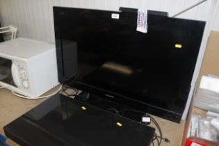 A Sony Bravia flat screen television with remote c