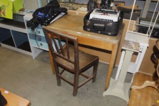 A vintage oak writing table and a 19th Century rail back chair