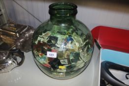 A green glass carboy and contents of souvenir matc