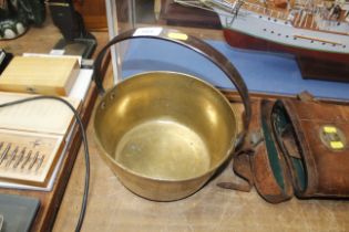 A brass preserve pan with iron handle