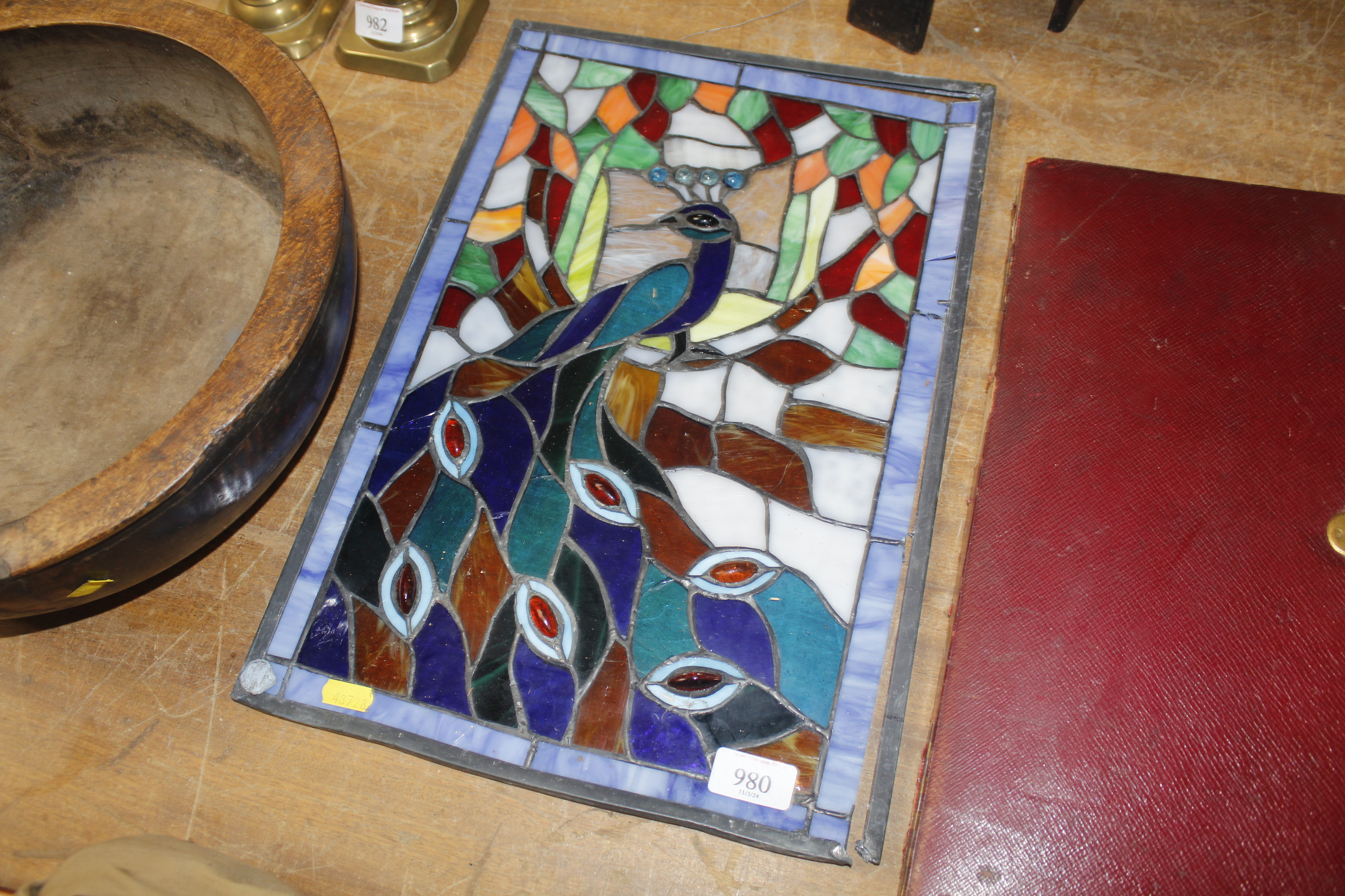 A stained glass panel decorated with a peacock