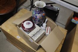 A box containing decorative vase, various other ce