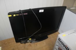 A Bush flat screen tv with remote control