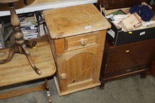 A stripped pine bedside cupboard, fitting single dra