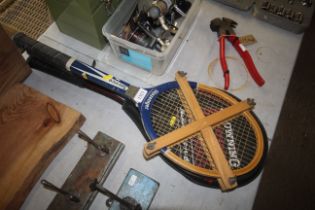 Two tennis rackets and a badminton racket