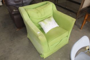 A modern bright green upholstered armchair