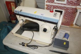 A Singer electric sewing machine and accessories