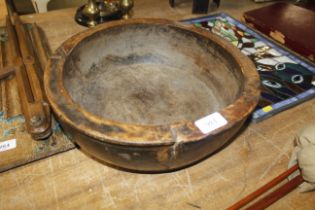 A large wooden bowl measuring approx. 14" diameter