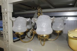 A brass and frosted glass firelight pendent ceilin