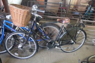 A lady's Pashley Princess bicycle with front and rear mud guards, front mounted wicker basket,