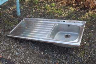 A stainless steel single basin sink with draining