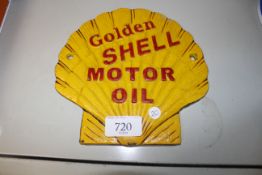 A reproduction Golden Shell motor oil sign