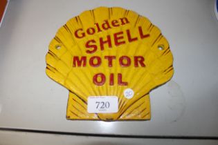 A reproduction Golden Shell motor oil sign