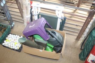 A box containing plastic watering cans, plastic st
