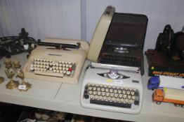 Three vintage portable typewriters