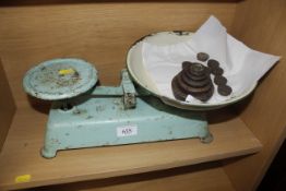 A set of cast iron kitchen scales and weights