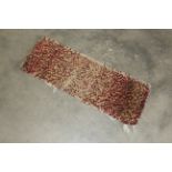 A small rag rug approx. 2'10" x 1'1"