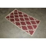 A trellis flat weave red rug approx. 4'10" x 2'8"