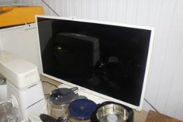 A Bush flat screen television with remote control