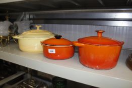 A Le Creuset saucepan and lid, another similar and