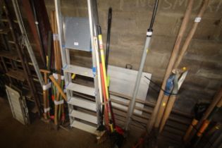 A quantity of long handled tools to include rake,