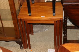 A nest of three teak occasional tables