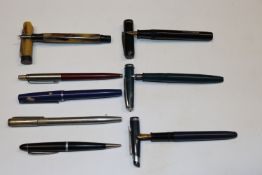 A collection of fountain pens and ball point pens