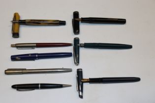 A collection of fountain pens and ball point pens
