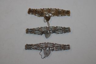 A silver gate link bracelet with padlock clasp and