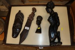 Four ebony and hardwood tribal carvings; and a lar
