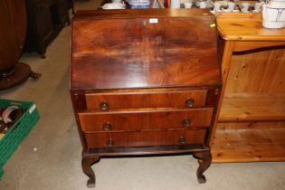 A mahogany three drawer bureau on cabriole support