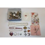 A box of various costume jewellery and wrist watch