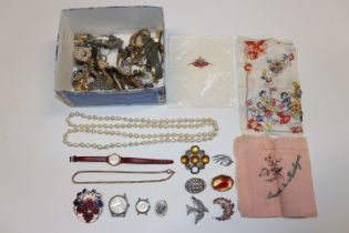 A box of various costume jewellery and wrist watch