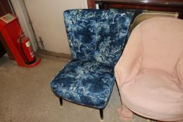 A cocktail chair, re-upholstered in Linwood fabric.