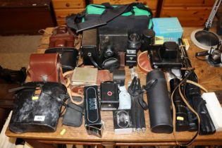 A large quantity of various cameras, binoculars, l