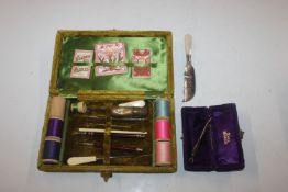 A cased sewing set; a mother of pearl handled and