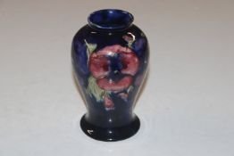 A Moorcroft Pottery floral decorated vase, 15.5cm