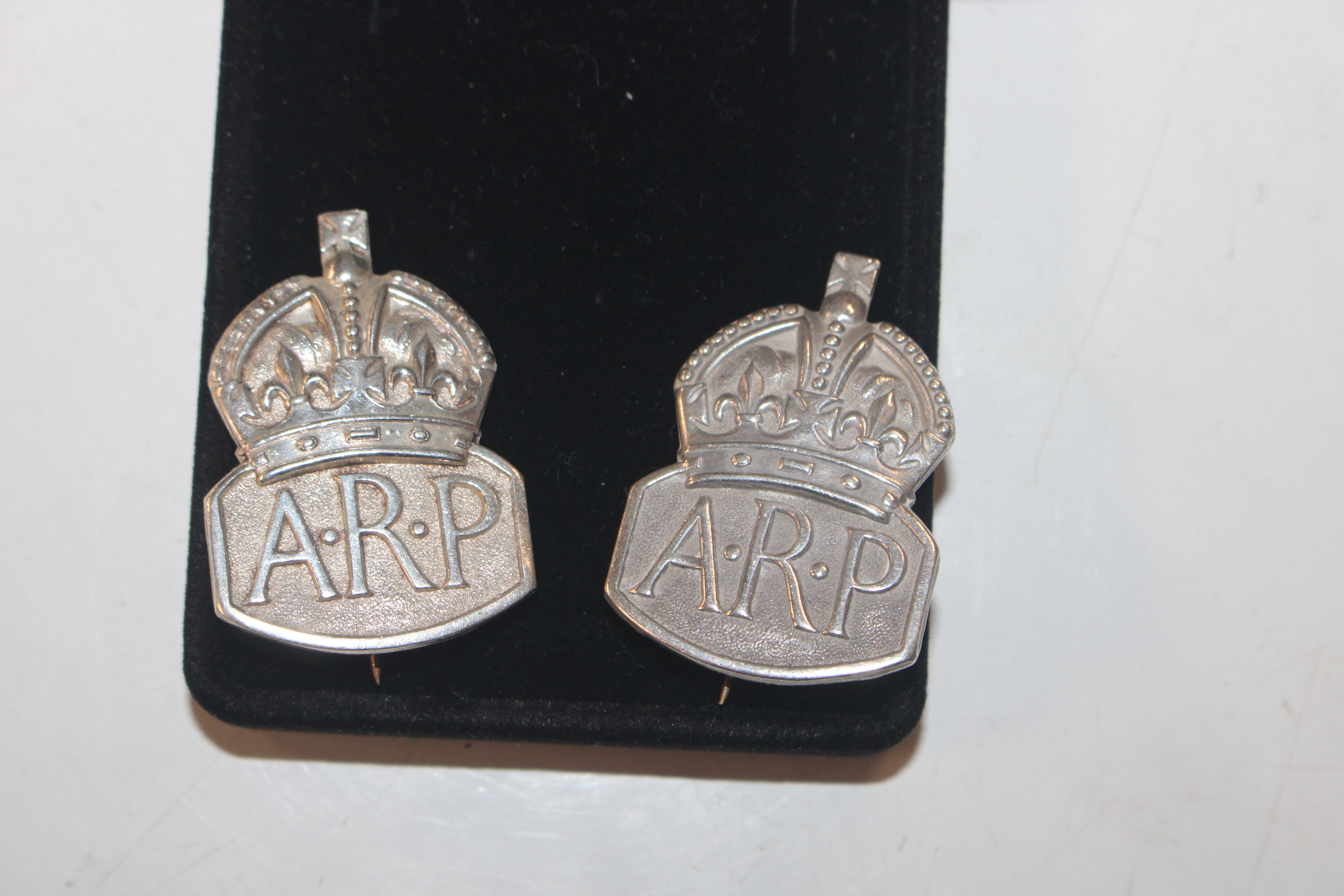 Two 1937 London Mint Sterling silver ARP badges, a