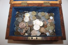 A wooden box and contents of world coinage