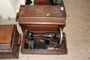 A Singer hand sewing machine in fitted case